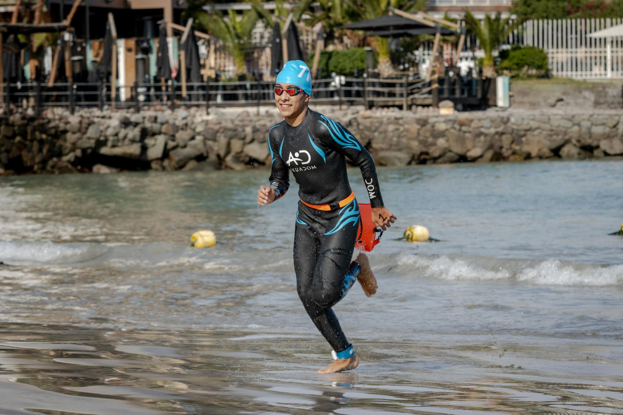 Man in swimsuit running on shore in triathlon